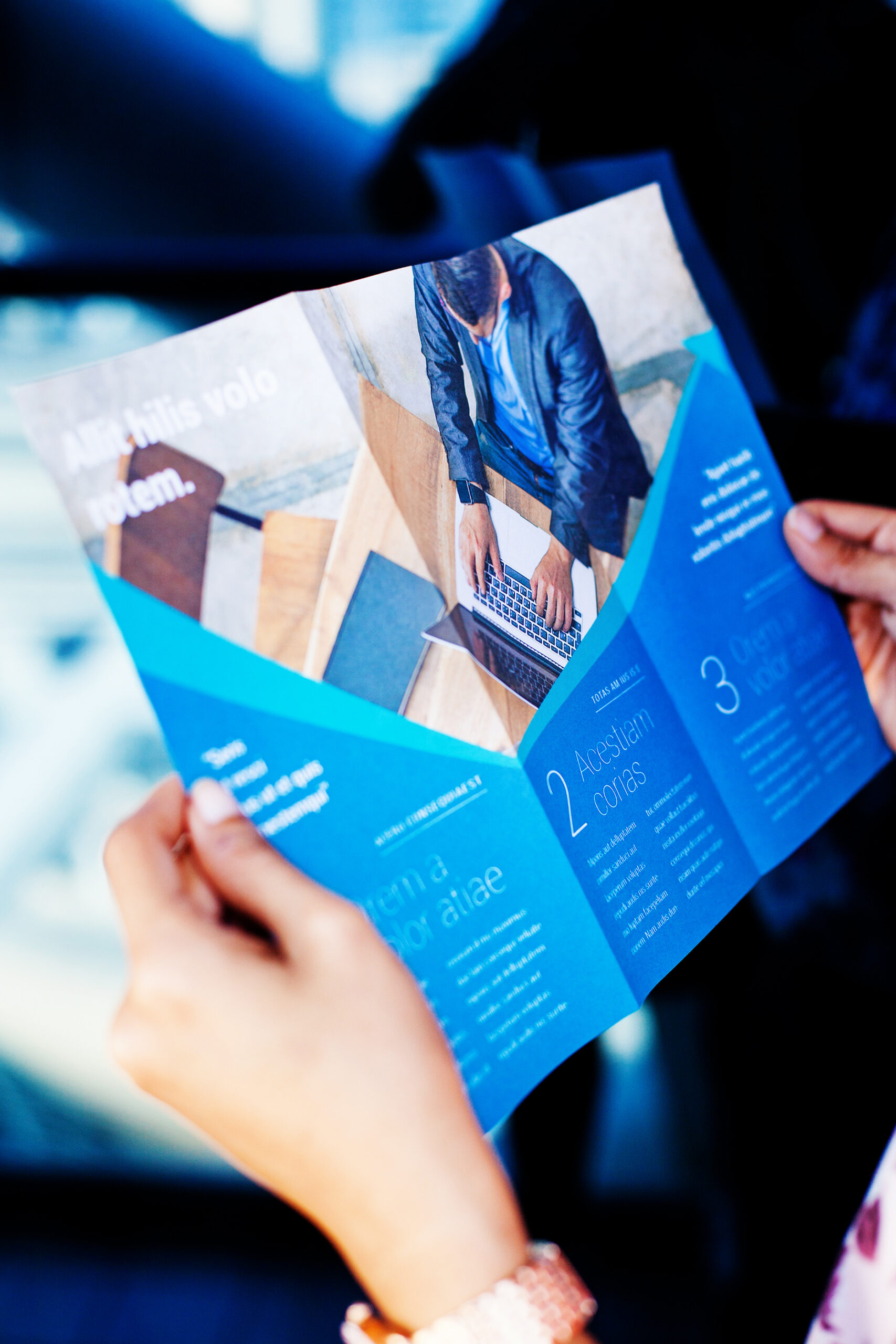 hands holding a business brochures